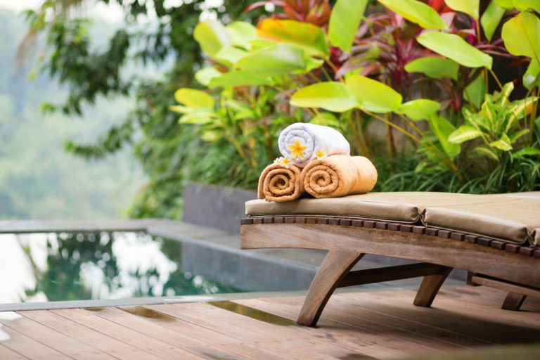 Towels with frangipani flowers in a Balinese spa