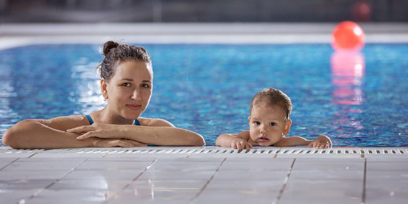 Mom with young child in swimming pool