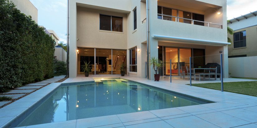Square house with backyard pool and deck
