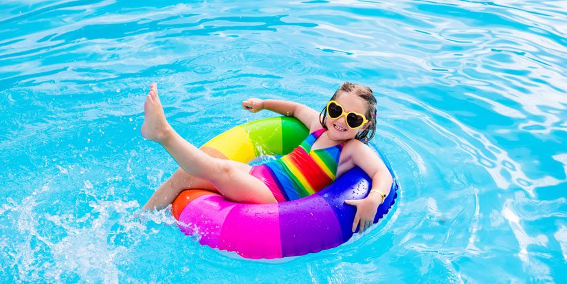Young girl floating on tube in pool