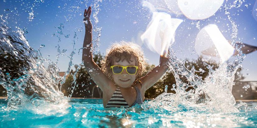 young-girl-splashing-bubbles-in-pool-water